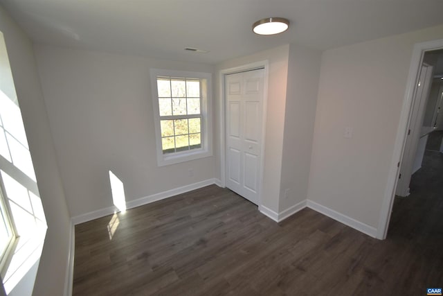 spare room featuring dark wood-type flooring