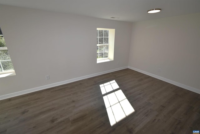 unfurnished room featuring dark hardwood / wood-style floors