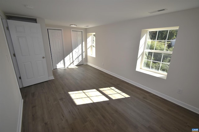 empty room featuring dark hardwood / wood-style flooring