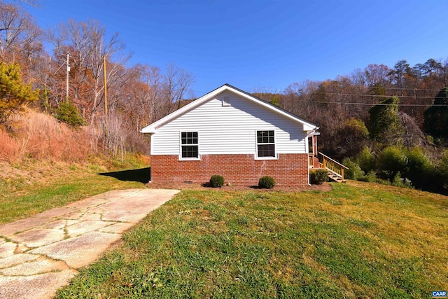 view of side of home with a yard