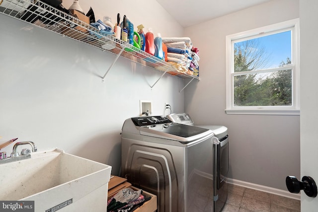 washroom featuring washer and clothes dryer and sink