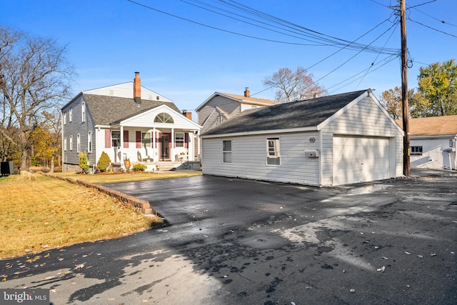 exterior space featuring a porch, a garage, and an outdoor structure