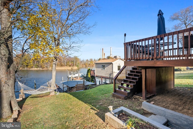 dock area with a deck with water view and a yard