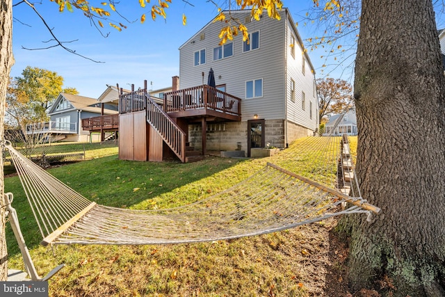 back of house with a yard and a wooden deck