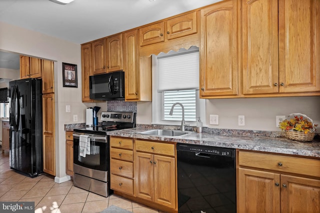 kitchen with light tile patterned floors, sink, and black appliances