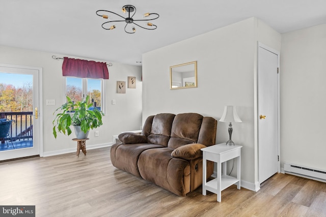 living room featuring a chandelier, a baseboard radiator, and light hardwood / wood-style floors