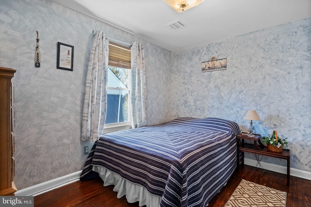 bedroom with dark wood-type flooring