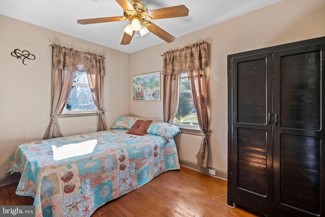 bedroom with ceiling fan and light hardwood / wood-style floors