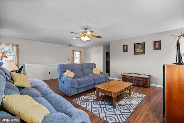 living room with ceiling fan and dark hardwood / wood-style flooring