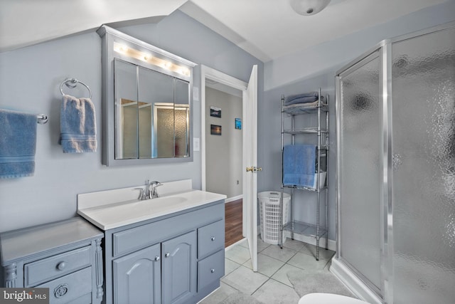 bathroom with tile patterned floors, vanity, and a shower with door