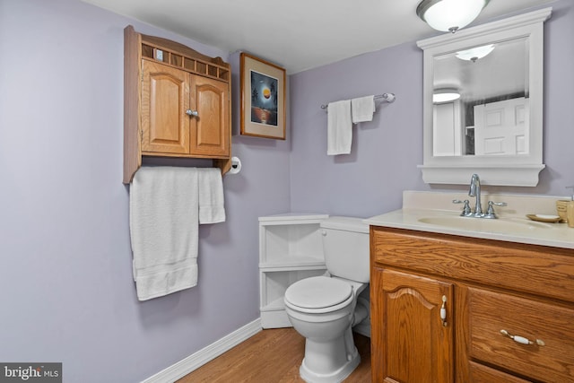 bathroom featuring hardwood / wood-style flooring, vanity, and toilet