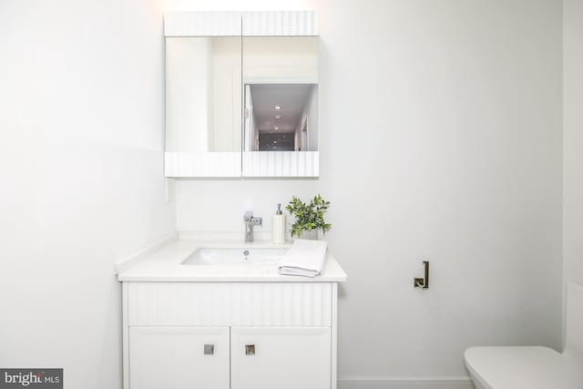 bathroom with vanity and toilet