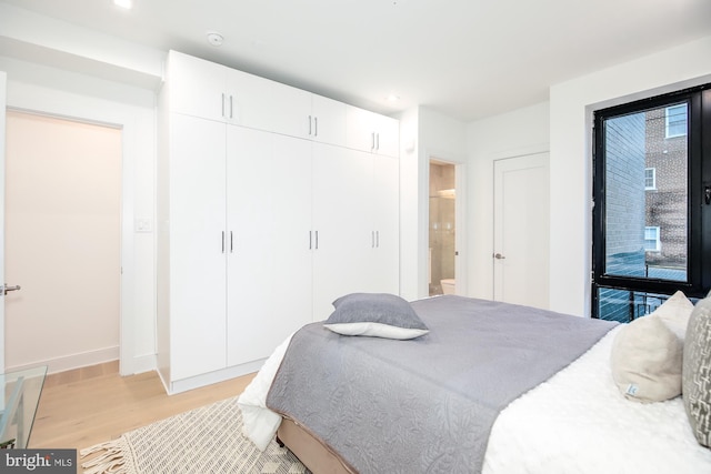 bedroom featuring access to outside and light hardwood / wood-style flooring