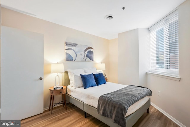 bedroom with hardwood / wood-style flooring