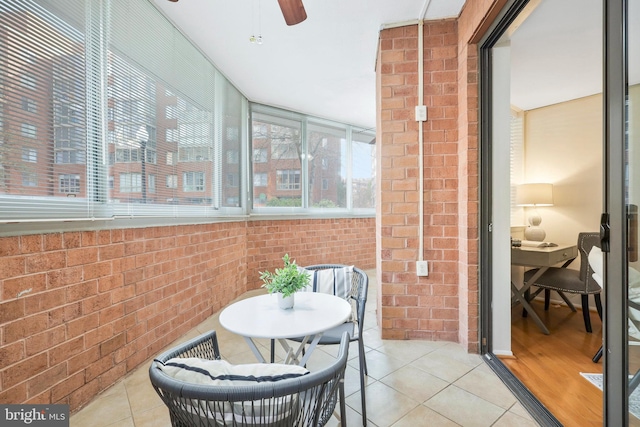 sunroom featuring ceiling fan