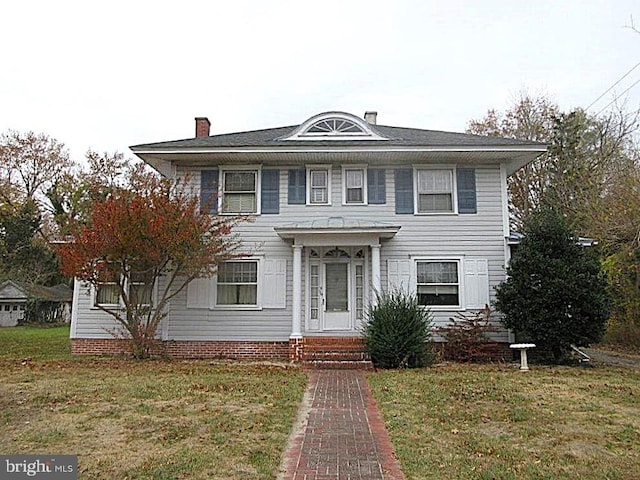 colonial home with a front yard