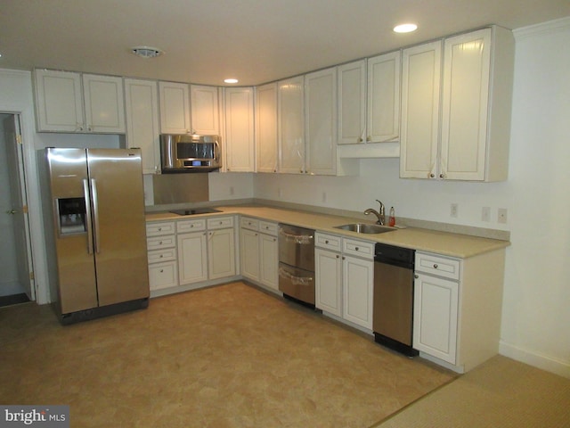 kitchen featuring sink, white cabinetry, and appliances with stainless steel finishes