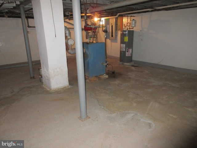 basement featuring electric panel and electric water heater