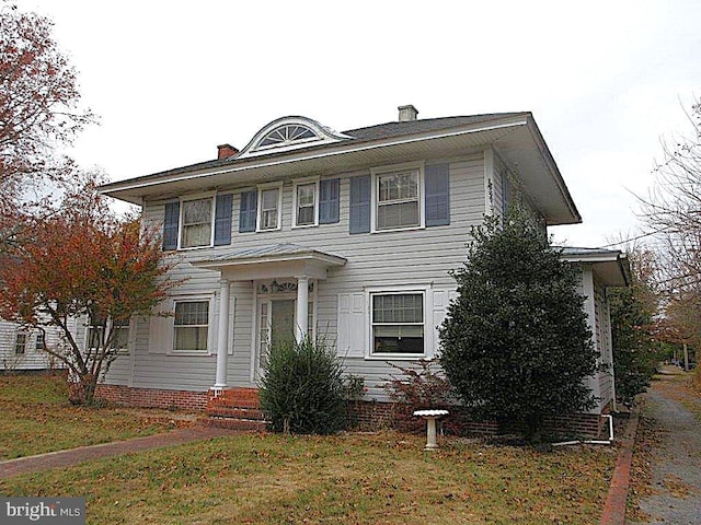 colonial house featuring a front yard