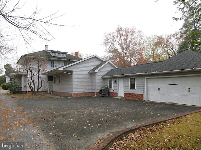 back of property featuring a garage