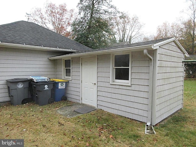 view of outbuilding with a lawn