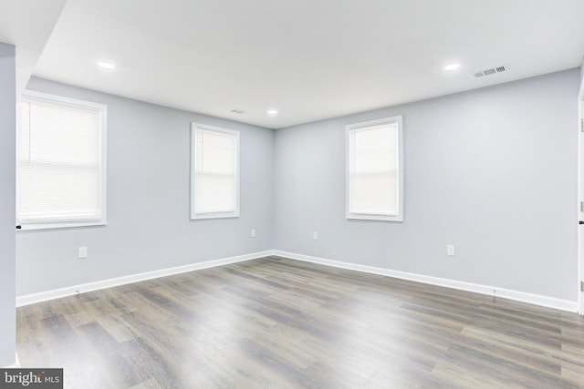 empty room featuring dark hardwood / wood-style floors and a wealth of natural light