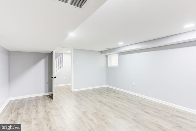 basement with light hardwood / wood-style floors