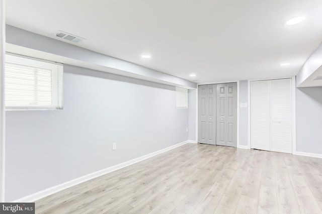 basement with light hardwood / wood-style flooring