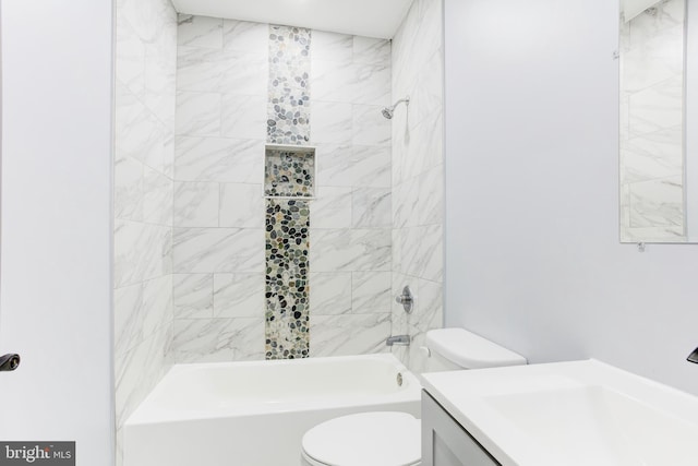 full bathroom with vanity, tiled shower / bath combo, and toilet