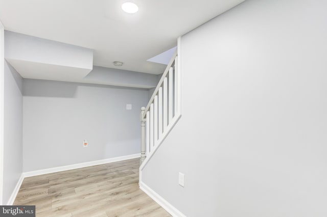 staircase with hardwood / wood-style flooring