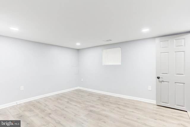 basement with light hardwood / wood-style flooring