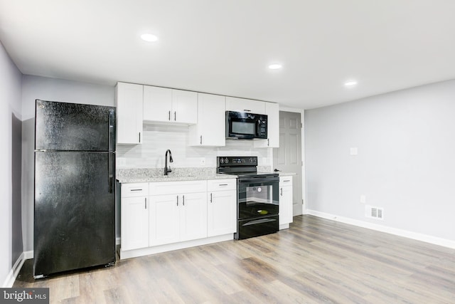 kitchen with white cabinets, light wood-type flooring, sink, and black appliances