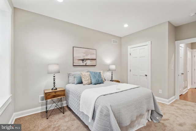 bedroom featuring light carpet