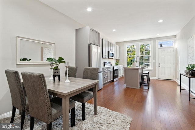 dining room with dark hardwood / wood-style flooring