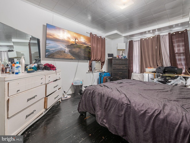 bedroom featuring cooling unit and dark wood-type flooring