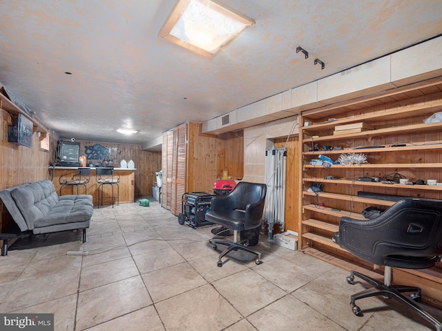 tiled home office with wood walls