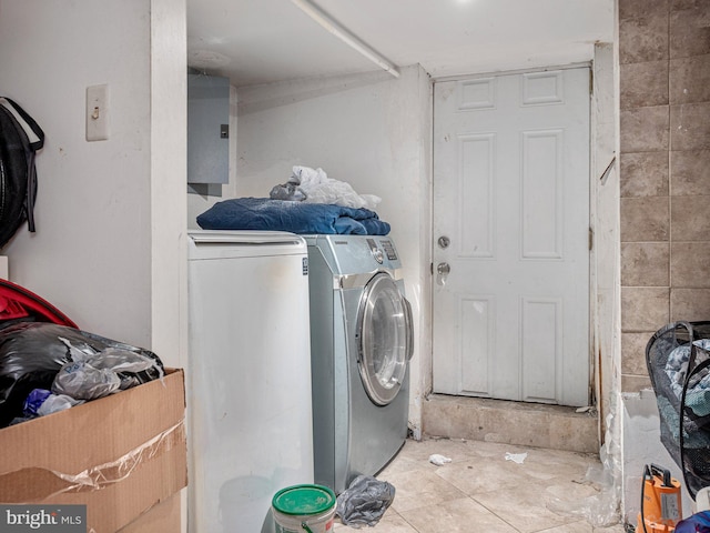 clothes washing area with tile patterned flooring and washer and dryer