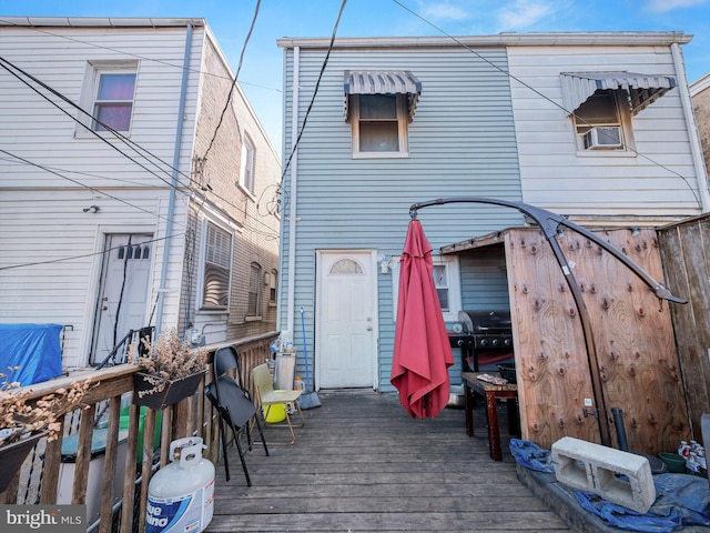 rear view of property featuring a deck