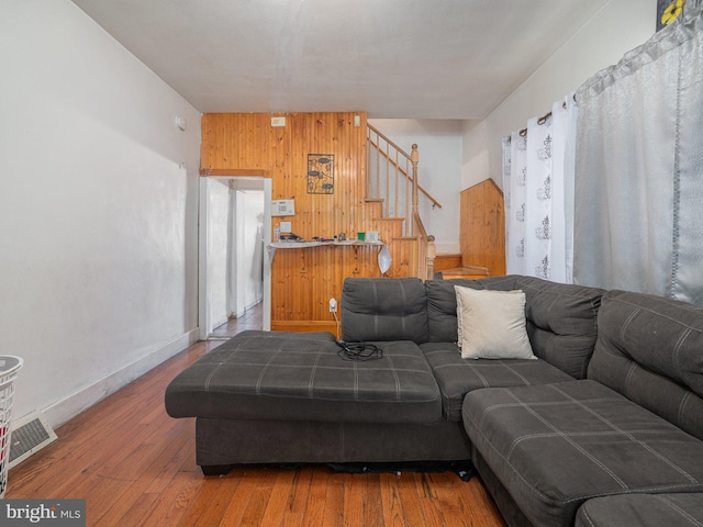 living room featuring wooden walls and wood-type flooring