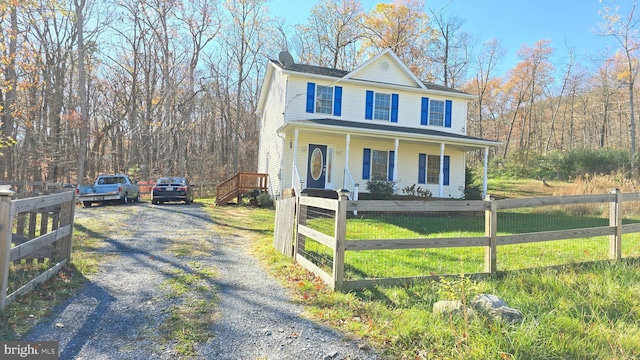 view of front facade with a front yard and a porch