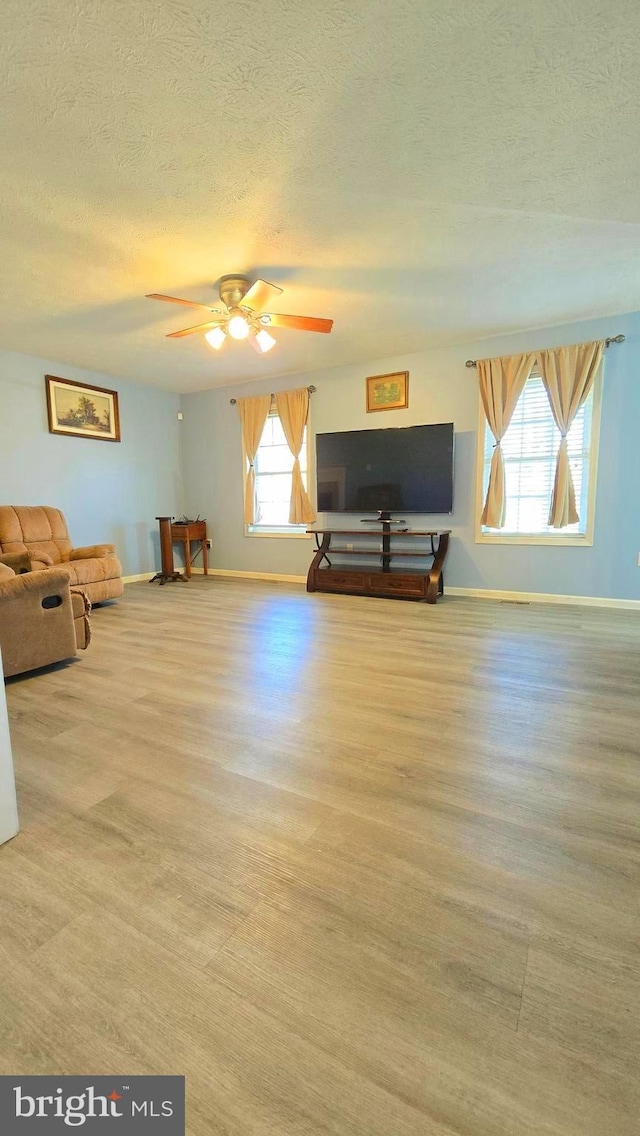 interior space featuring ceiling fan and a textured ceiling