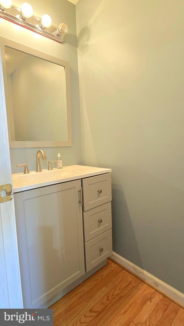 bathroom featuring hardwood / wood-style floors and vanity