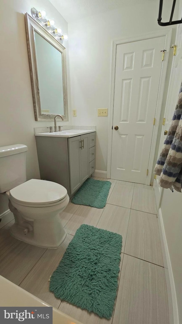 bathroom featuring vanity and toilet