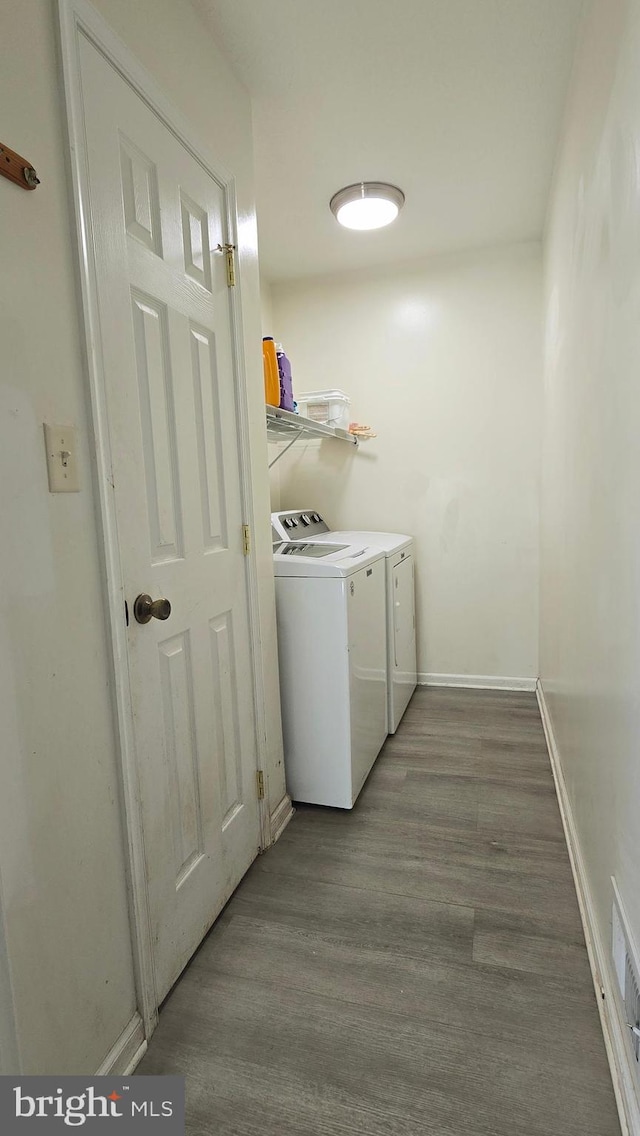 laundry area featuring washer and dryer and wood-type flooring