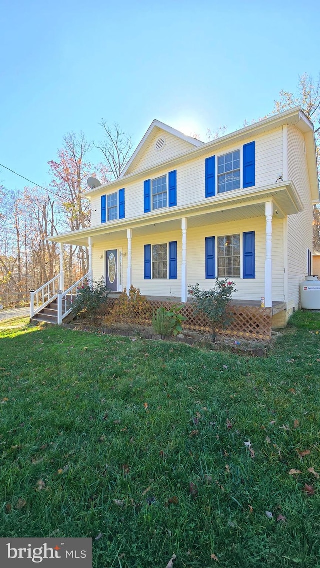 view of front of house with a front yard and covered porch