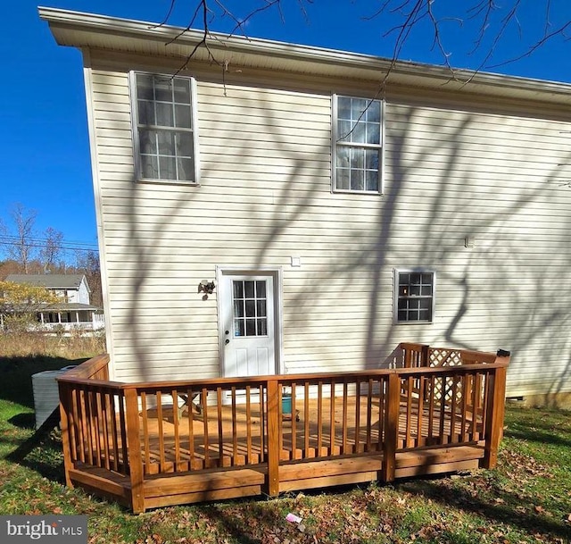 back of property featuring a wooden deck