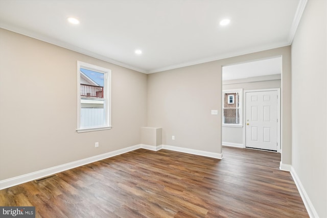 empty room featuring dark hardwood / wood-style floors and ornamental molding