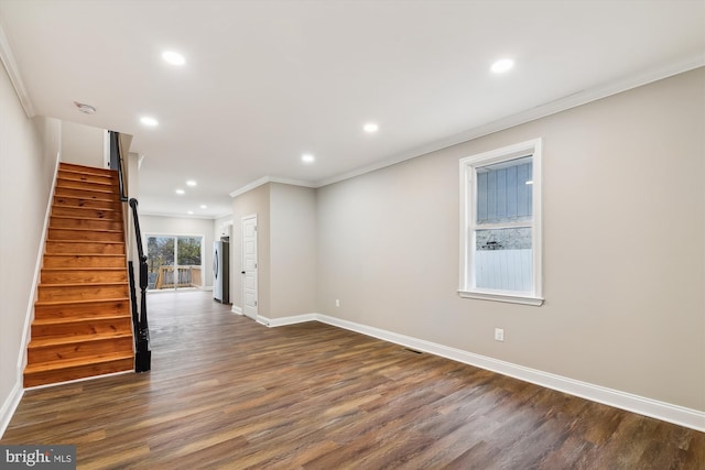 interior space featuring dark hardwood / wood-style flooring, ornamental molding, and washer / clothes dryer