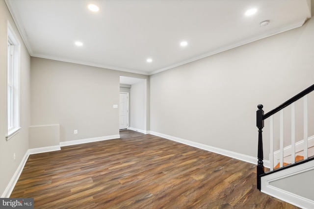 unfurnished room featuring crown molding and dark wood-type flooring