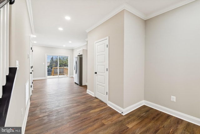 hallway with ornamental molding and dark wood-type flooring